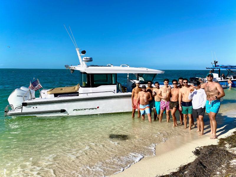 bachelor group on sandbar by axopar boat charter