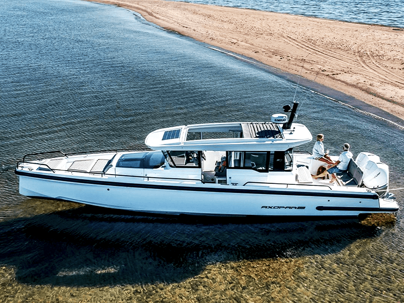 axopar boat exterior couple on back on the water