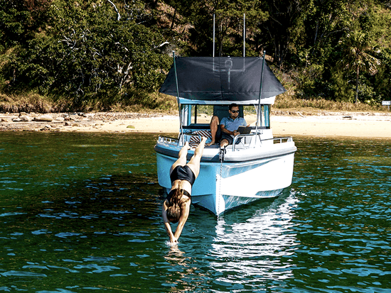 axopar 37 xc cross cabin boat woman diving into water