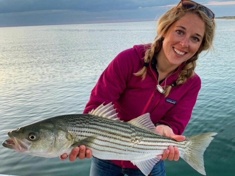 woman holding fish on boat charter