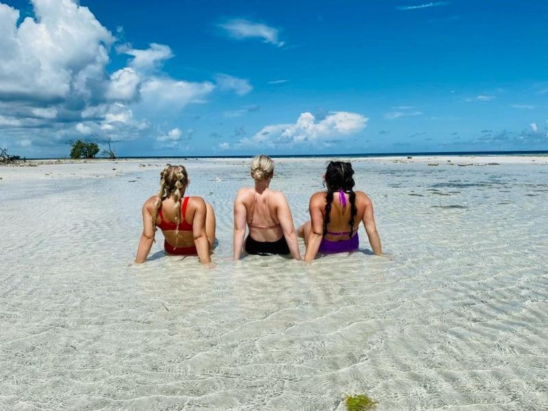 women relaxing on sandbar in Florida