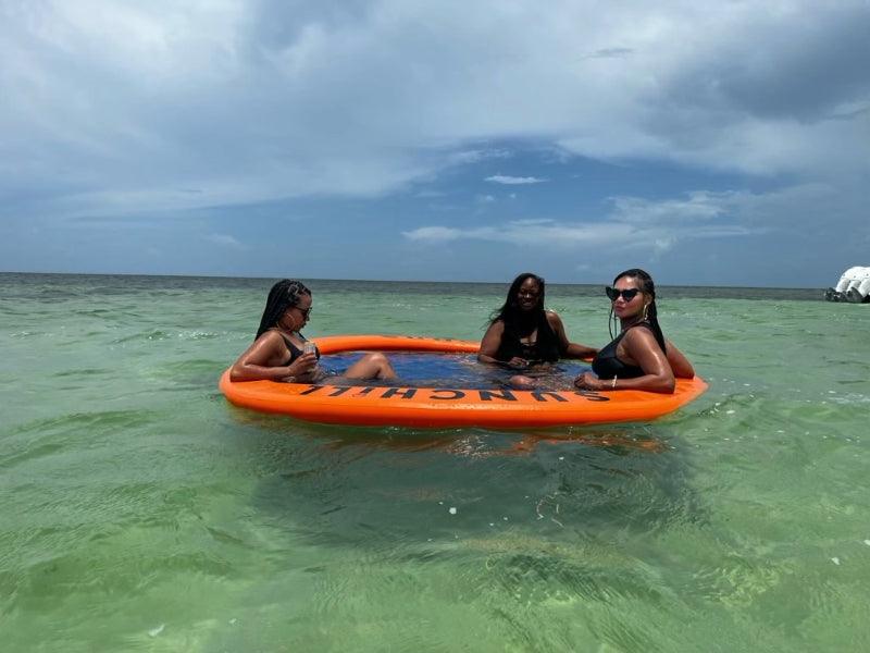 three women on float in Florida ocean