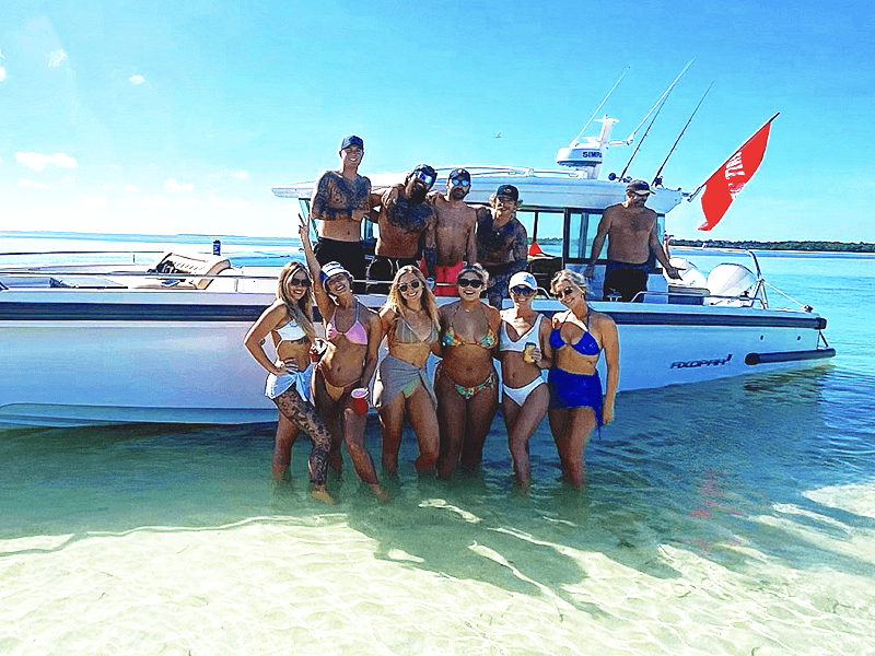 party group on sandbar on boat charter