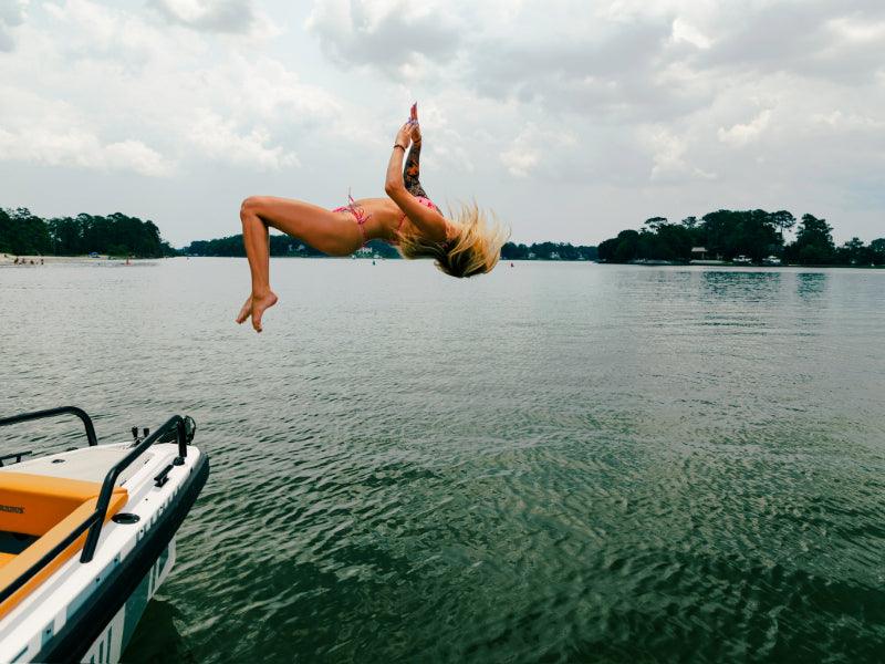woman backflips off of charter boat into ocean