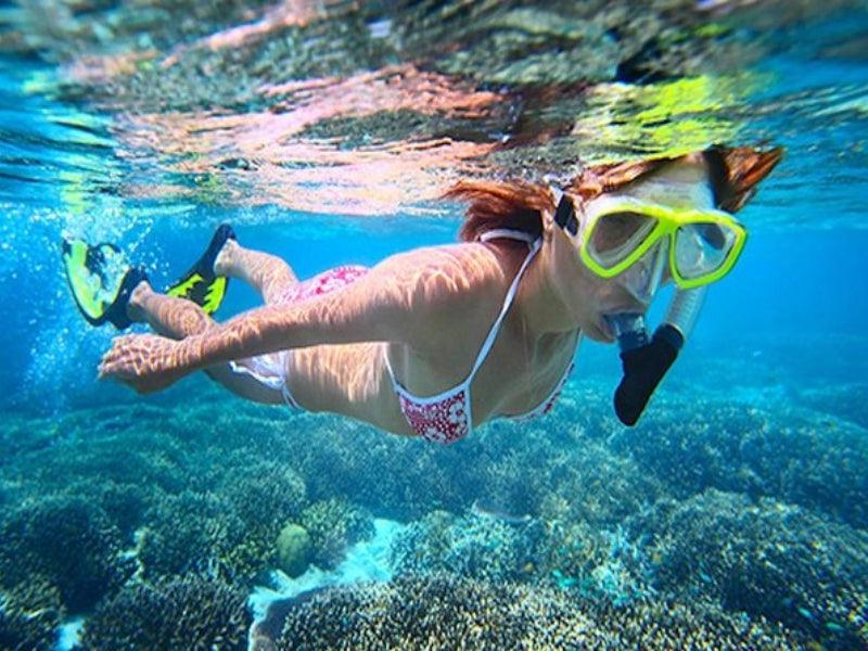 woman snorkeling by reefs in Florida Keys