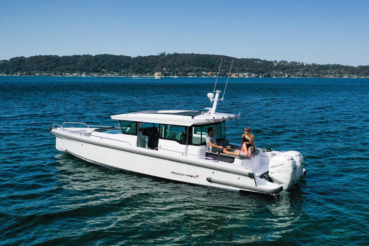 axopar 37 xc cross cabin exterior couple on the back