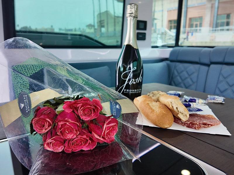 brunch with flowers and wine inside luxury yacht