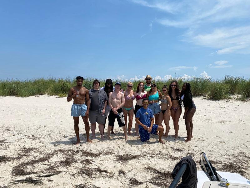 group of friends on sandbar virginia