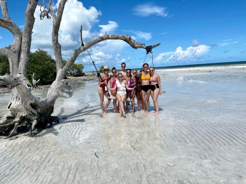 group of friends on sandbar swing in Florida