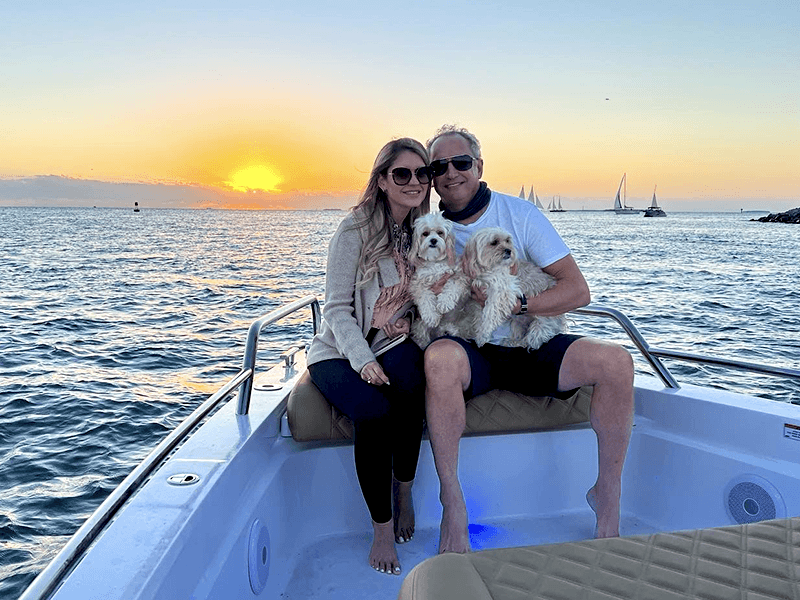 couple with dogs on boat charter