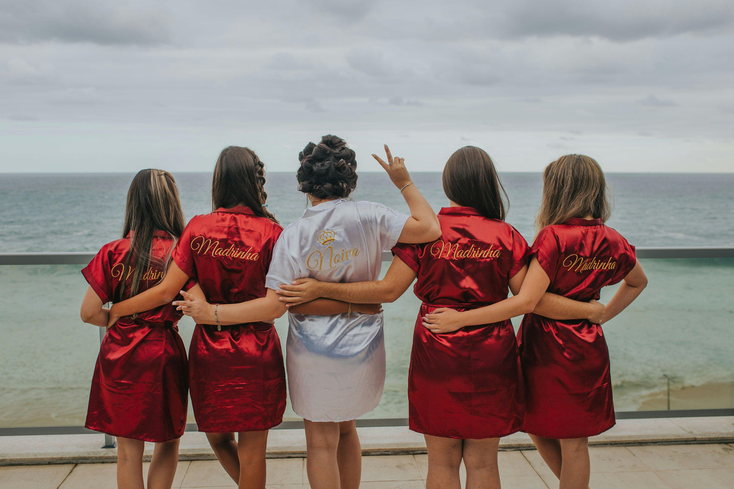 A bachelorette party with matching robes ready for a luxury boat rental and charter.