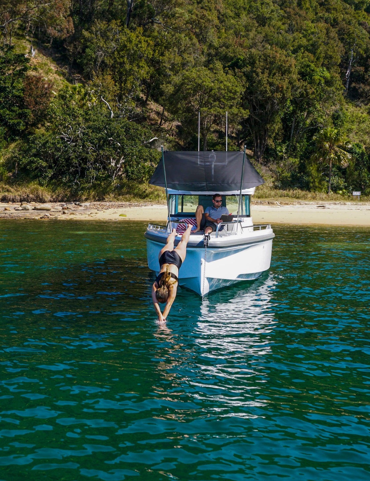 boat charter woman diving off into ocean